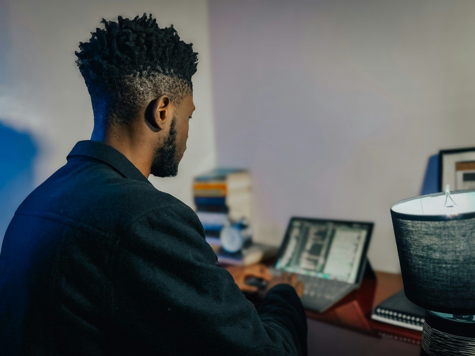 A man sitting at a desk working on a computer